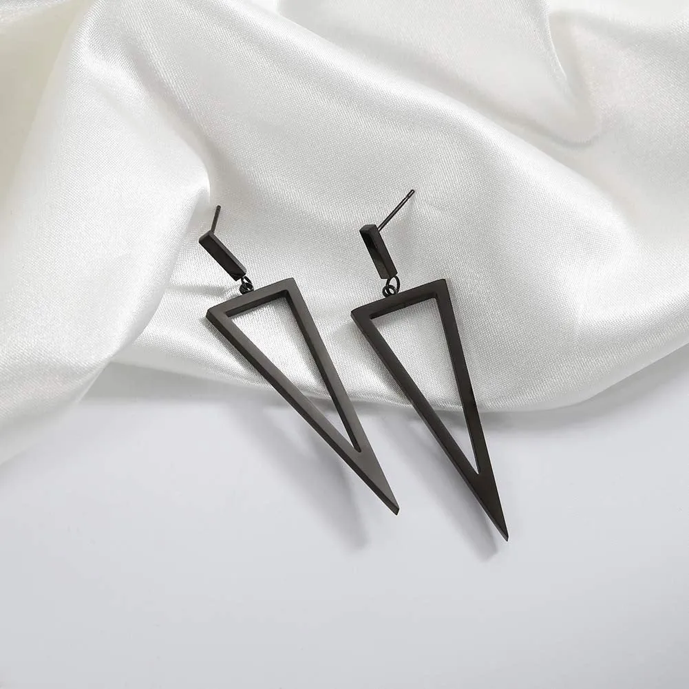 Black metal triangle earrings with electroplated finish on a plain background