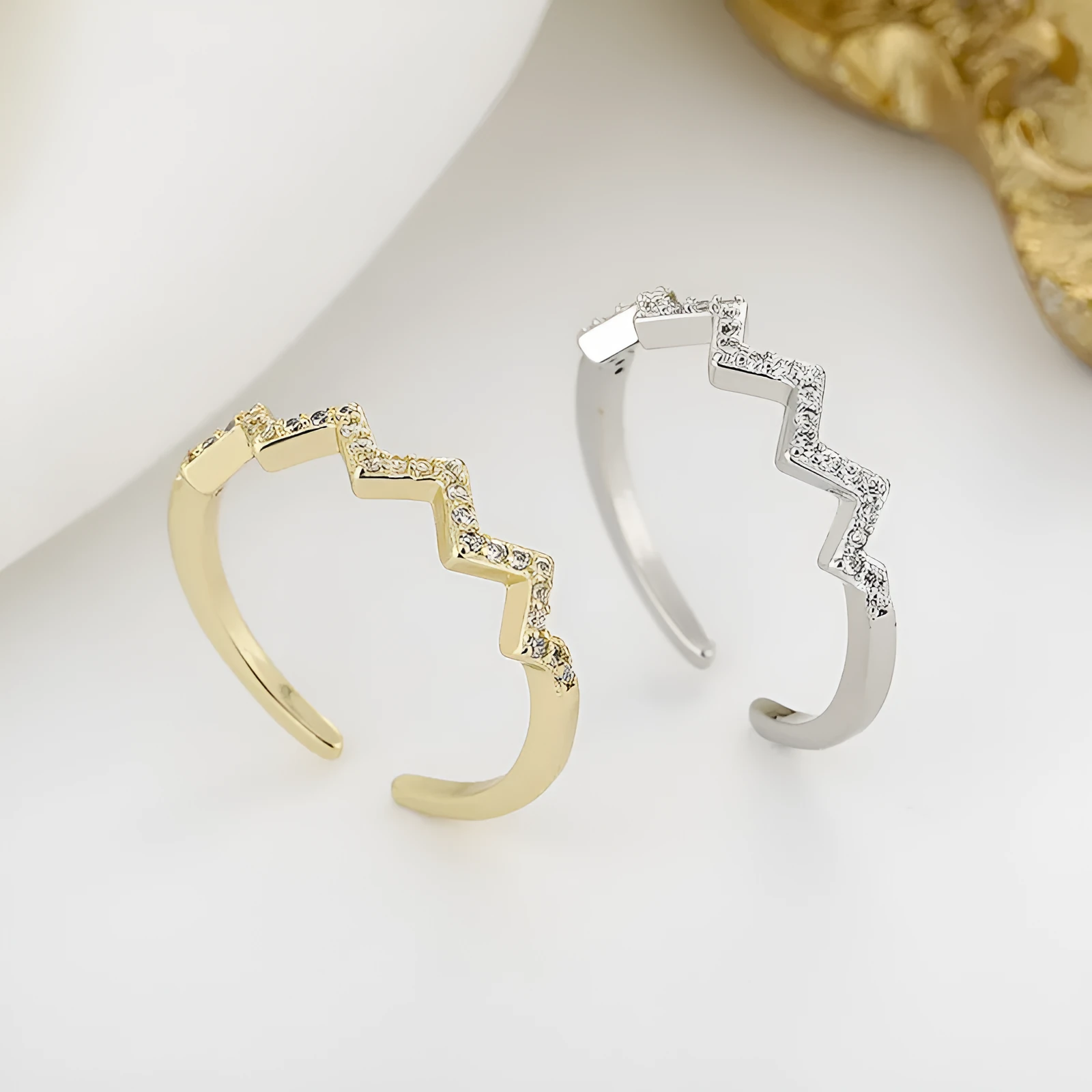 ECG Wave V-shaped zircon ring in gold colour on white background