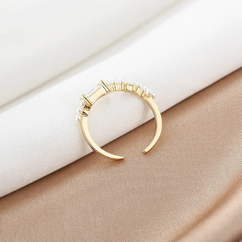 Gold alloy ring with square artificial gemstone inlay and diamond-cut surface, adjustable opening, on a white background