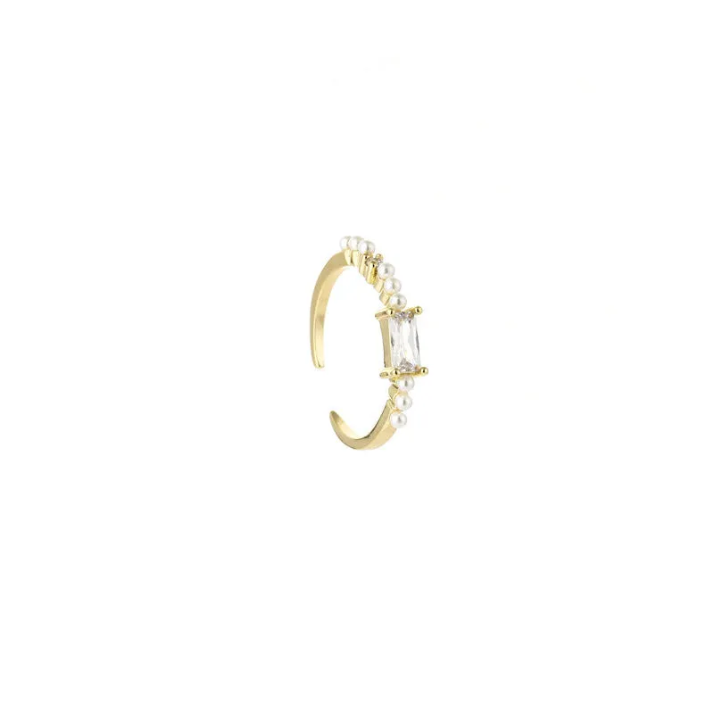 Gold alloy ring with square artificial gemstone inlay and diamond-cut surface, adjustable opening, on a white background