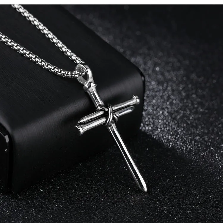 Titanium steel cross nail pendant necklace for men in silver finish on display