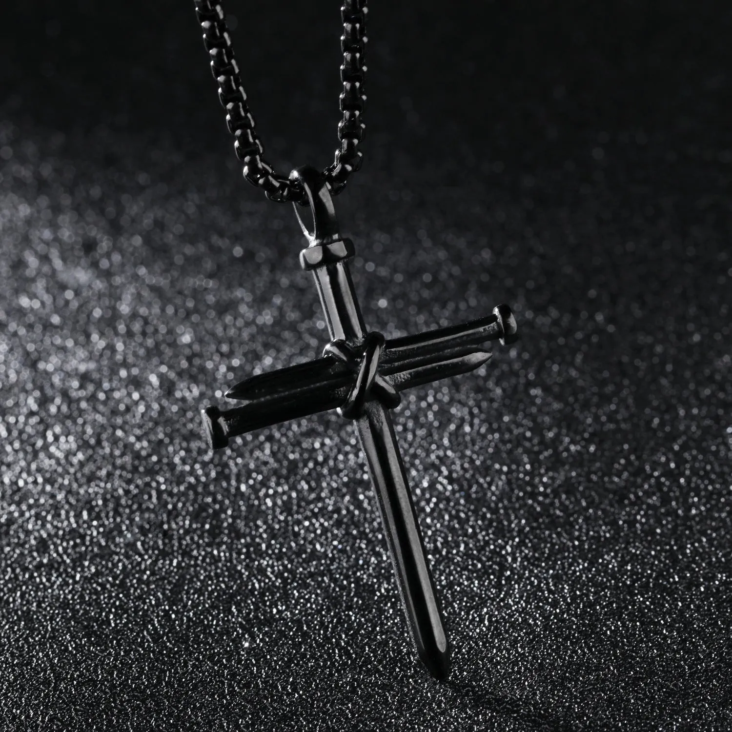 Titanium steel cross nail pendant necklace for men in silver finish on display