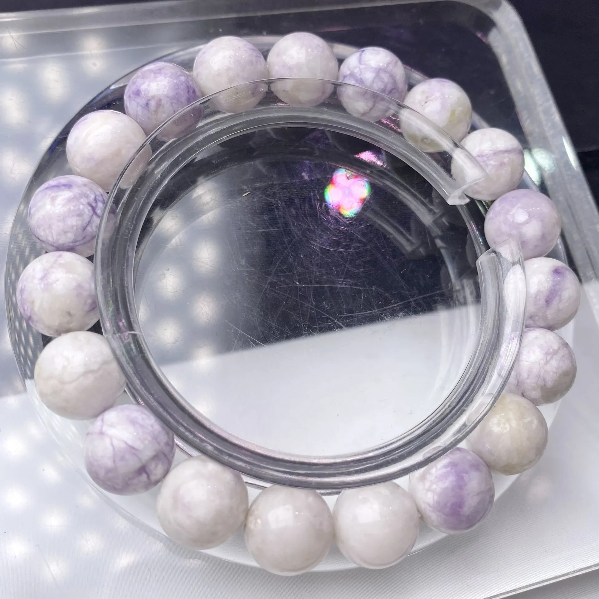 Women's purple turquoise stone bracelet with natural beads on a wrist.