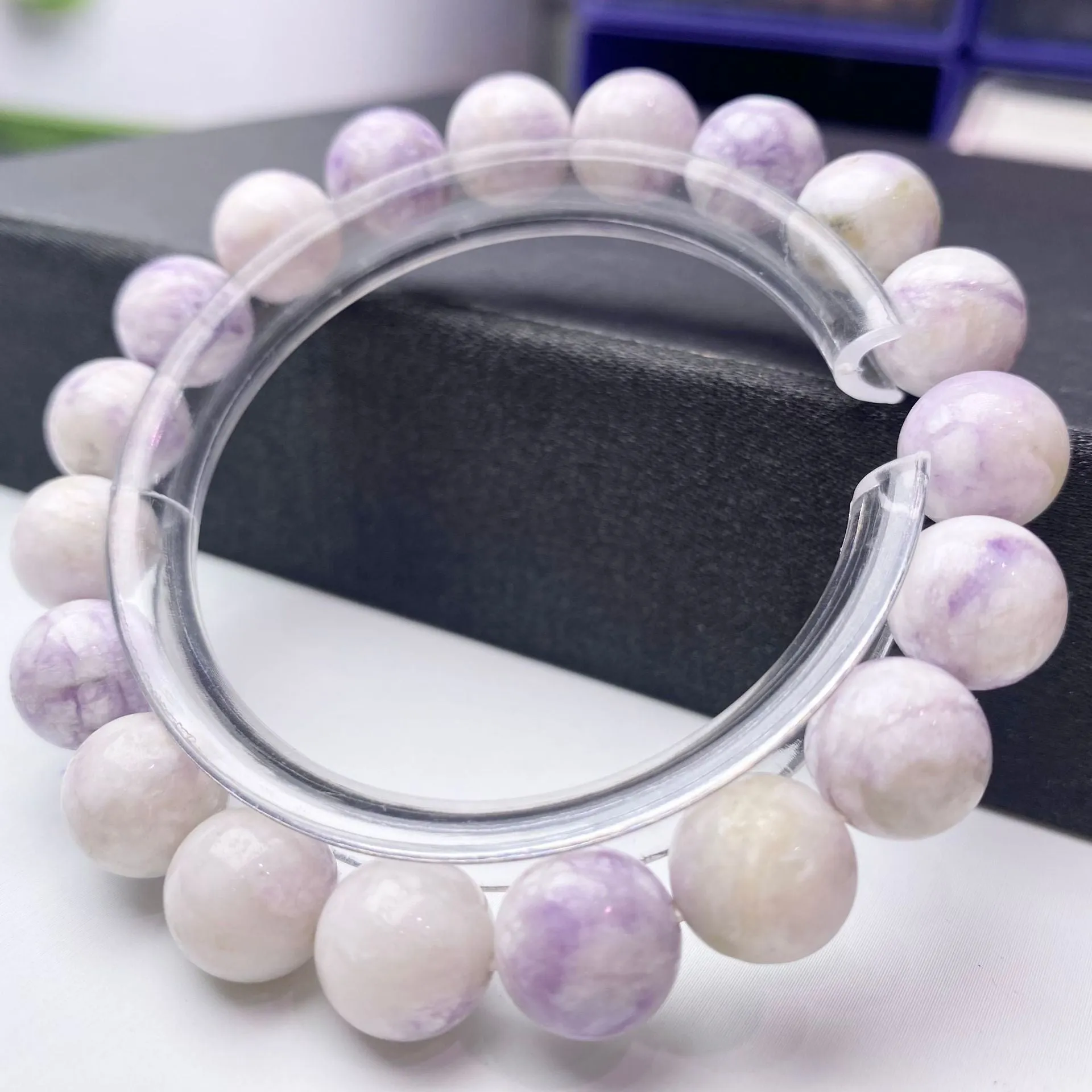 Women's purple turquoise stone bracelet with natural beads on a wrist.