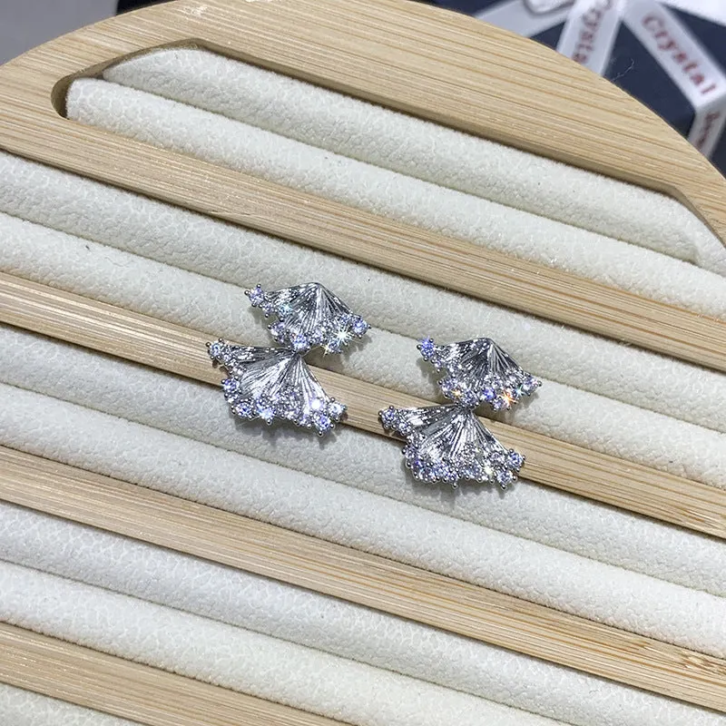 Minimalist irregular zircon stud dangle earrings in gold colour on a white background