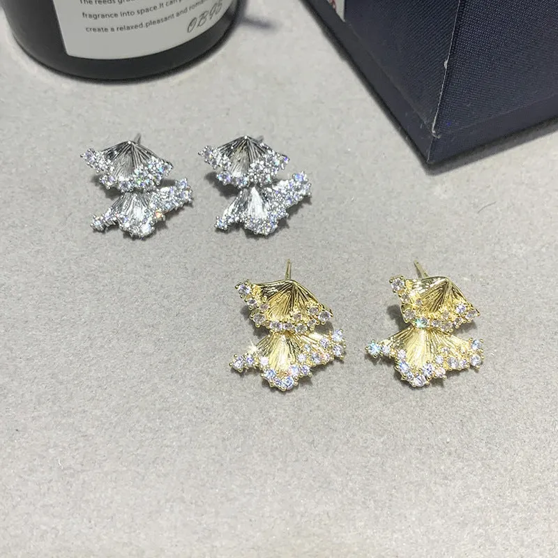 Minimalist irregular zircon stud dangle earrings in gold colour on a white background