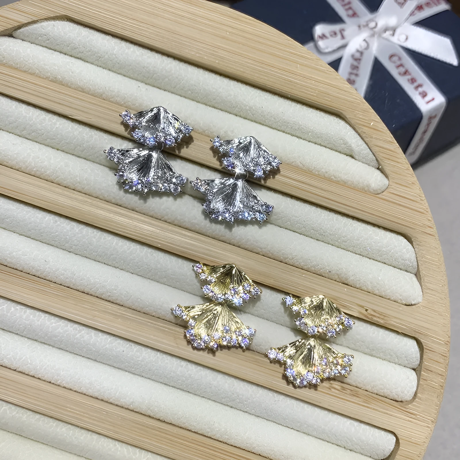 Minimalist irregular zircon stud dangle earrings in gold colour on a white background