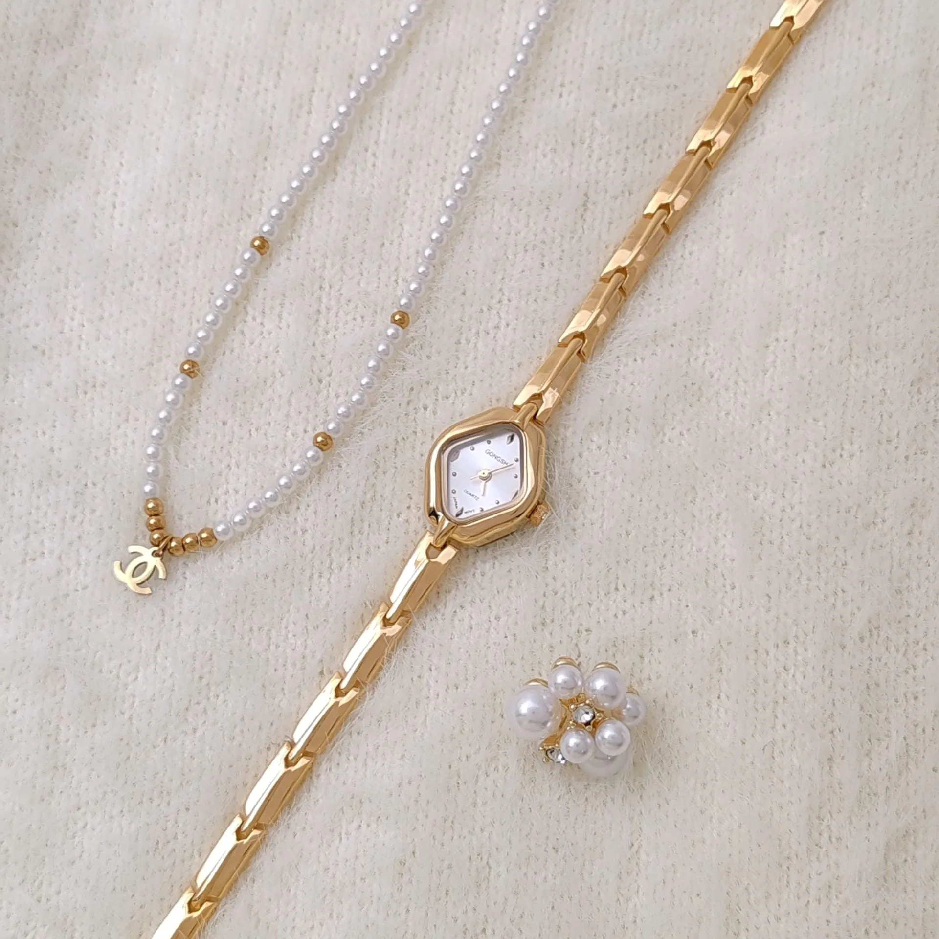 Ladies diamond fashion watch with gold or silver finish and chain strap, showing 7mm thickness and mineral glass face
