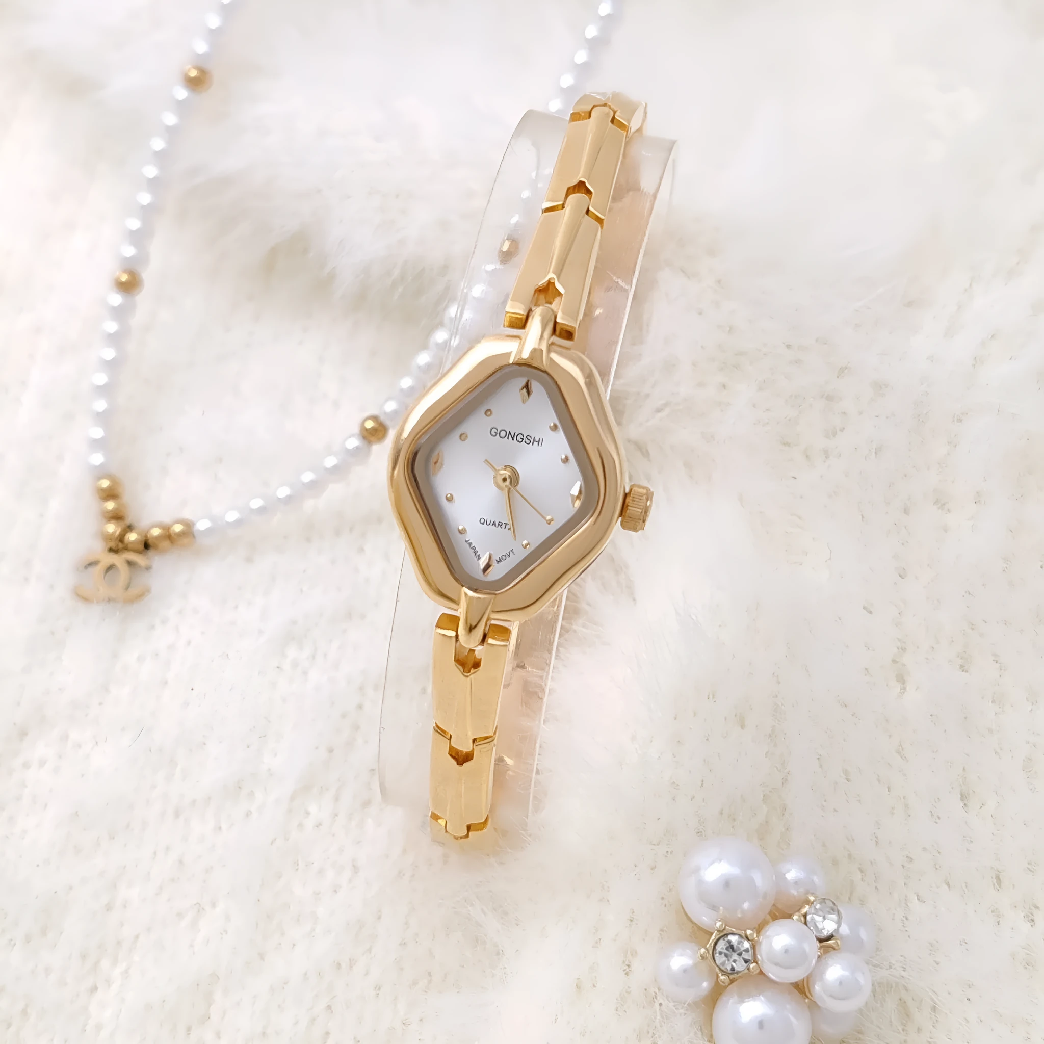 Ladies diamond fashion watch with gold or silver finish and chain strap, showing 7mm thickness and mineral glass face
