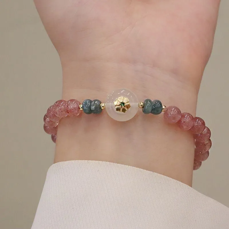 Women's strawberry quartz bracelet with blue water emerald jade pendant, geometric shapes, and traditional Chinese symbolism