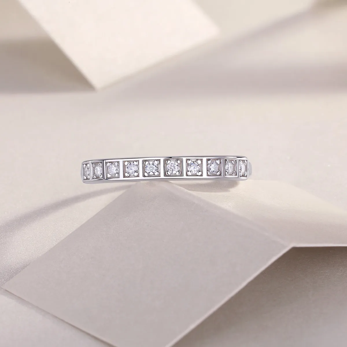 Moissanite wedding ring set on white background, S925 silver platinum plated, less than 0.1 carat stone
