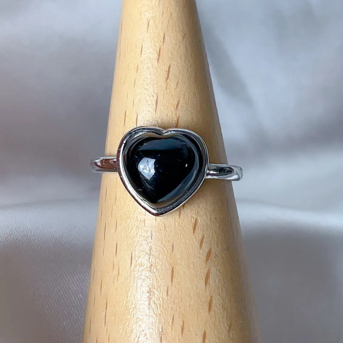 Copper open ring with crystal inlay, geometric shape, black tourmaline colour, on white background