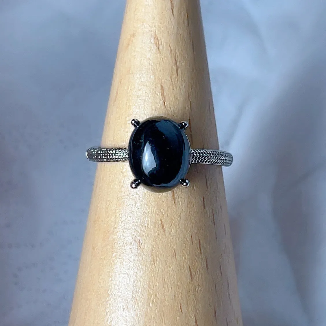 Copper open ring with crystal inlay, geometric shape, black tourmaline colour, on white background
