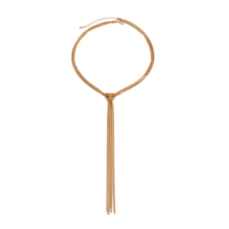 Simple Y-shaped metal tassel necklace set with gold finish and matching earrings on white background