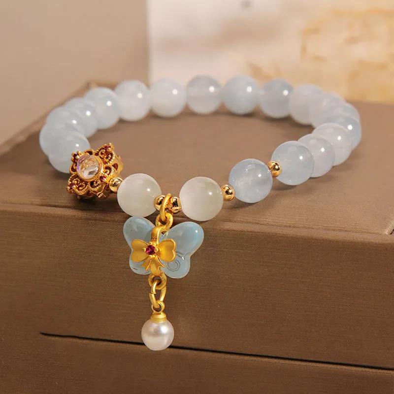 Aquamarine butterfly pendant crystal bracelet for women with rhinestone details on silver chain.