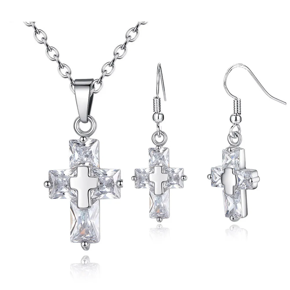 Gold cross pendant and matching stud earrings set on a light background showing compact 1.2 x 2.2 cm pendant and 3.3 x 1.2 cm studs