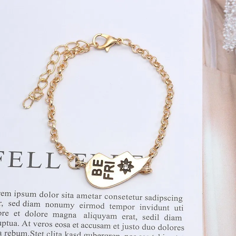 Heart shape alloy bracelet with dripping oil finish and inlaid gems in gold and silver colours