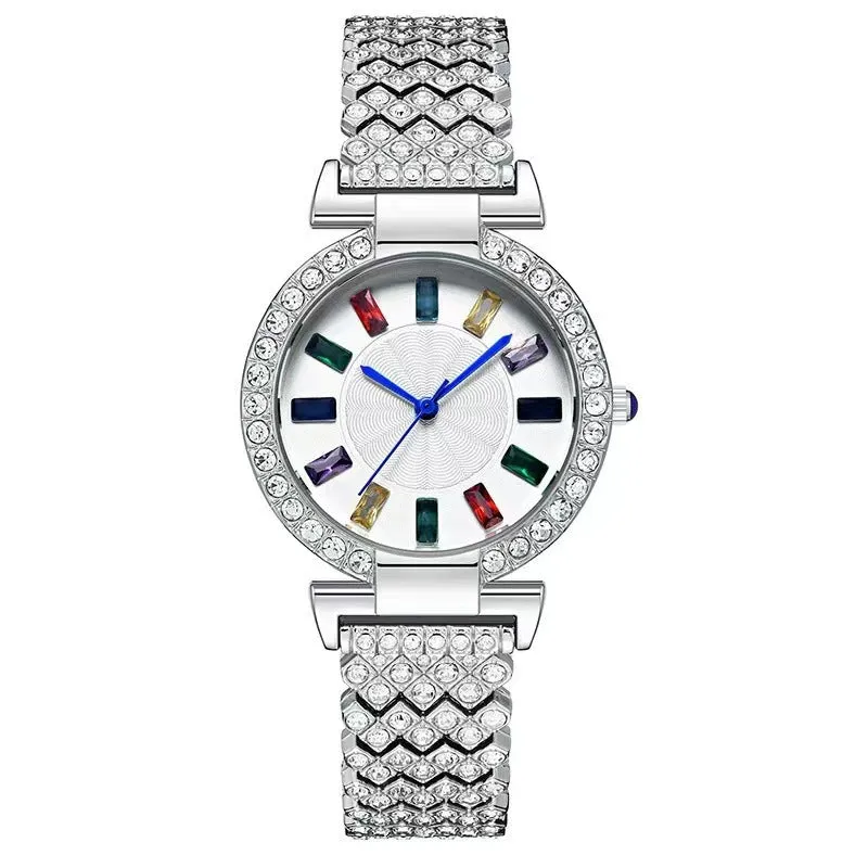 Gold quartz bracelet watch with round dial and alloy band on white background