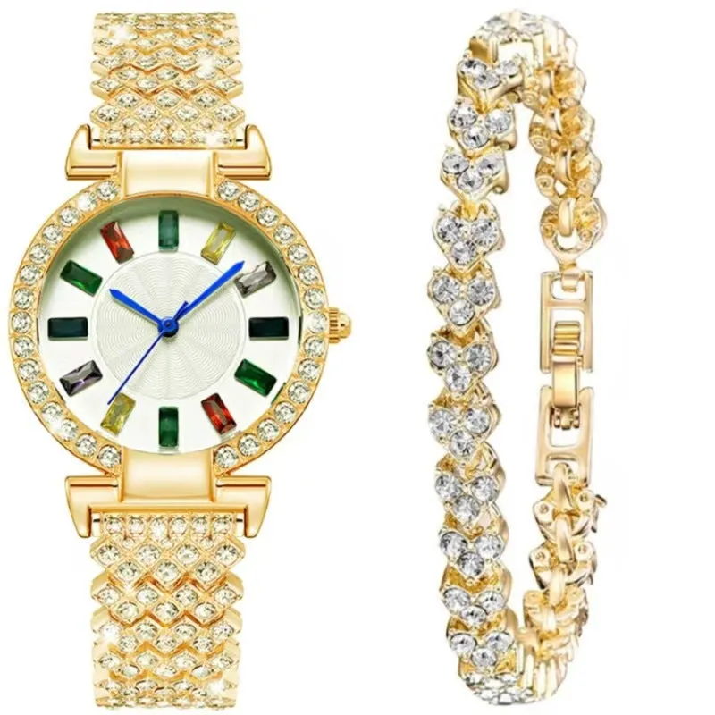 Gold quartz bracelet watch with round dial and alloy band on white background