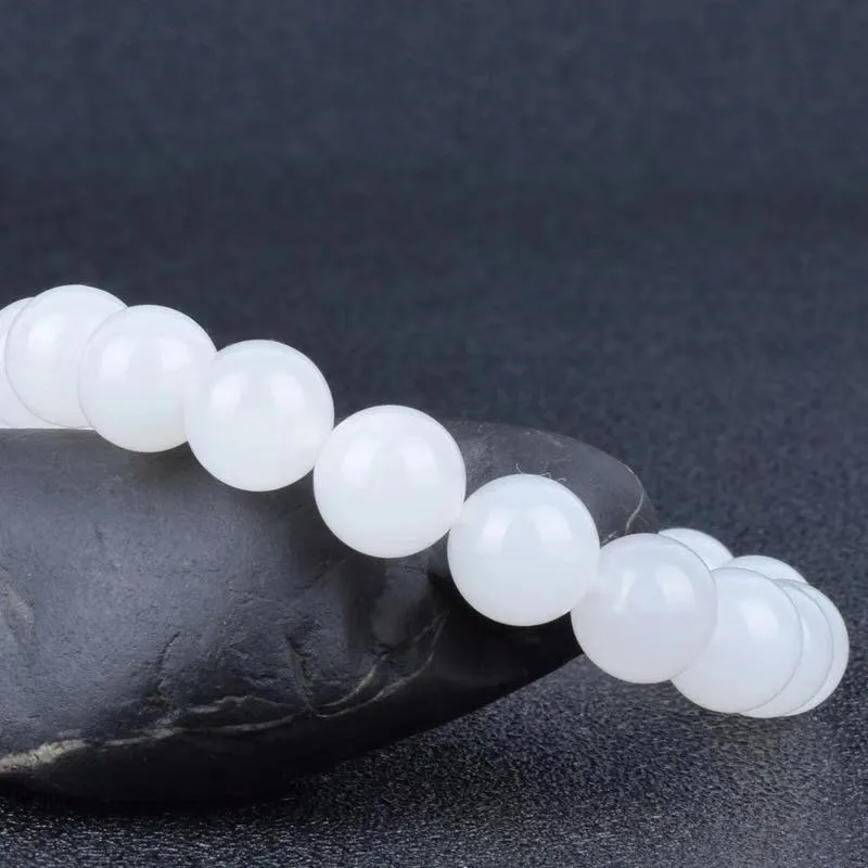 Hotan white jade goat fat round bead bracelet 10mm Hetian jade unisex national style on light background