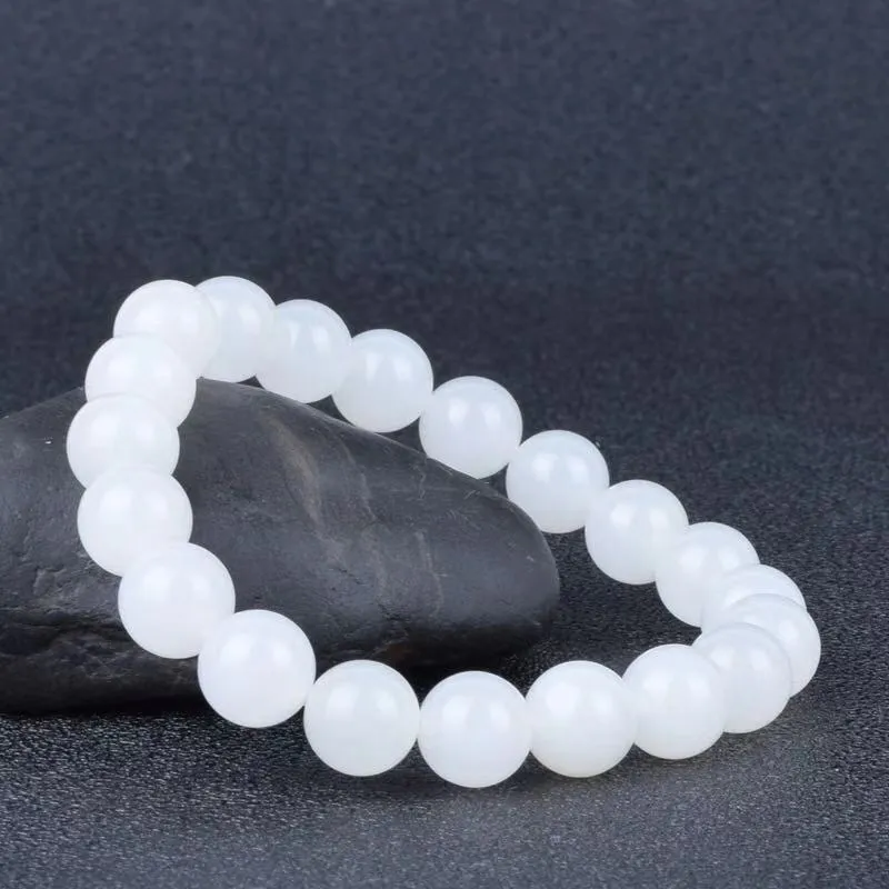Hotan white jade goat fat round bead bracelet 10mm Hetian jade unisex national style on light background