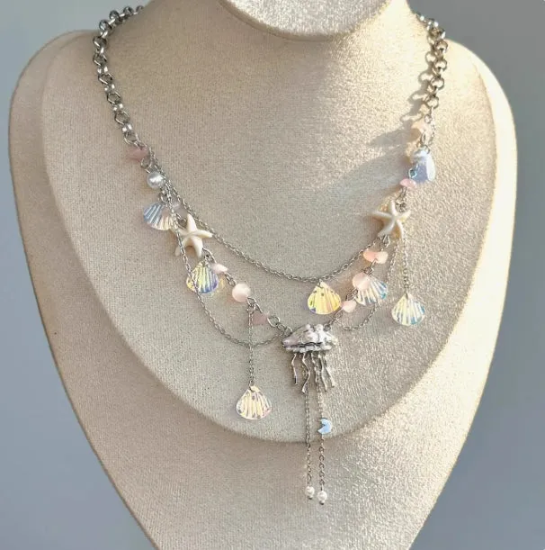 Frosted jellyfish pendant necklace and earrings in multiple colour options on a white background