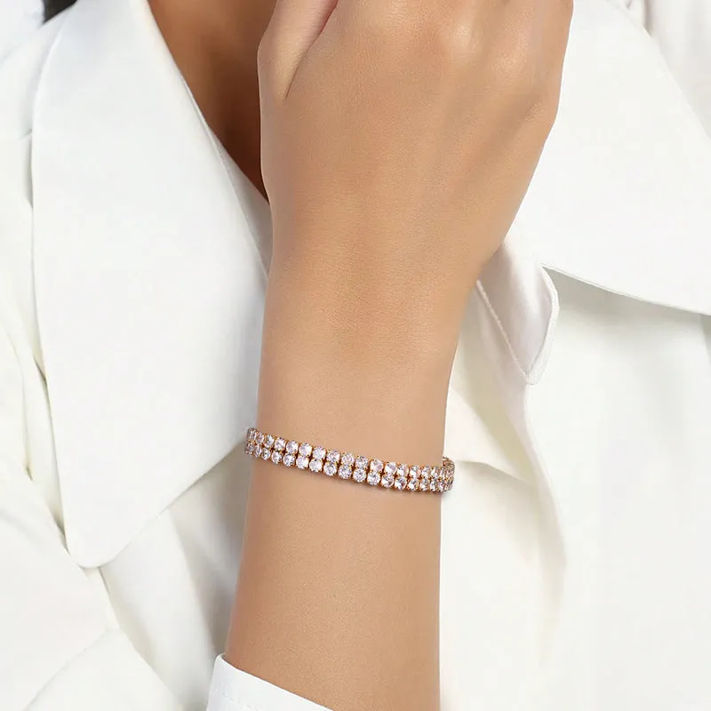 Unisex gold electroplated double-row diamond zirconia tennis chain bracelet on white background