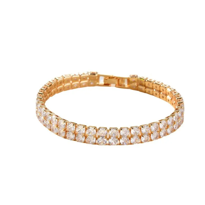 Unisex gold electroplated double-row diamond zirconia tennis chain bracelet on white background