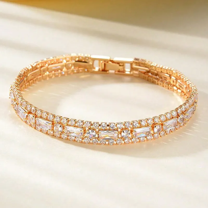 Unisex gold electroplated double-row diamond zirconia tennis chain bracelet on white background