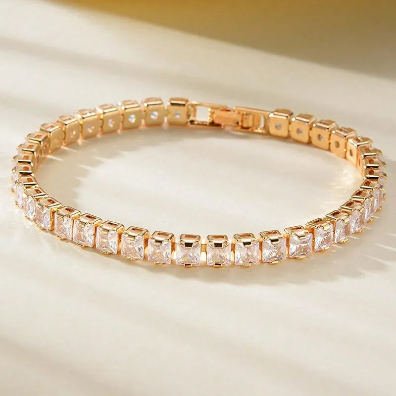 Unisex gold electroplated double-row diamond zirconia tennis chain bracelet on white background