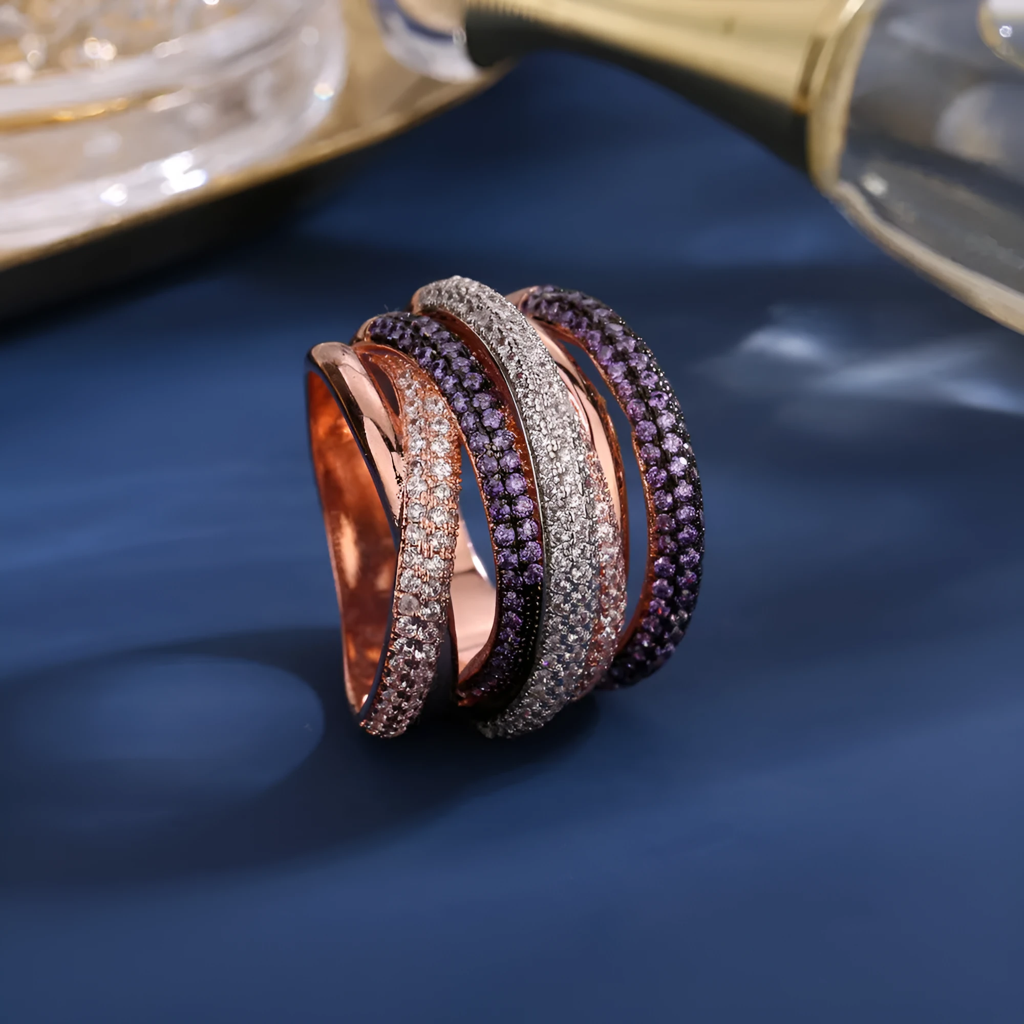 Women's geometric cross line ring with colour-separated zirconia stones in green, red, yellow, purple on a copper band