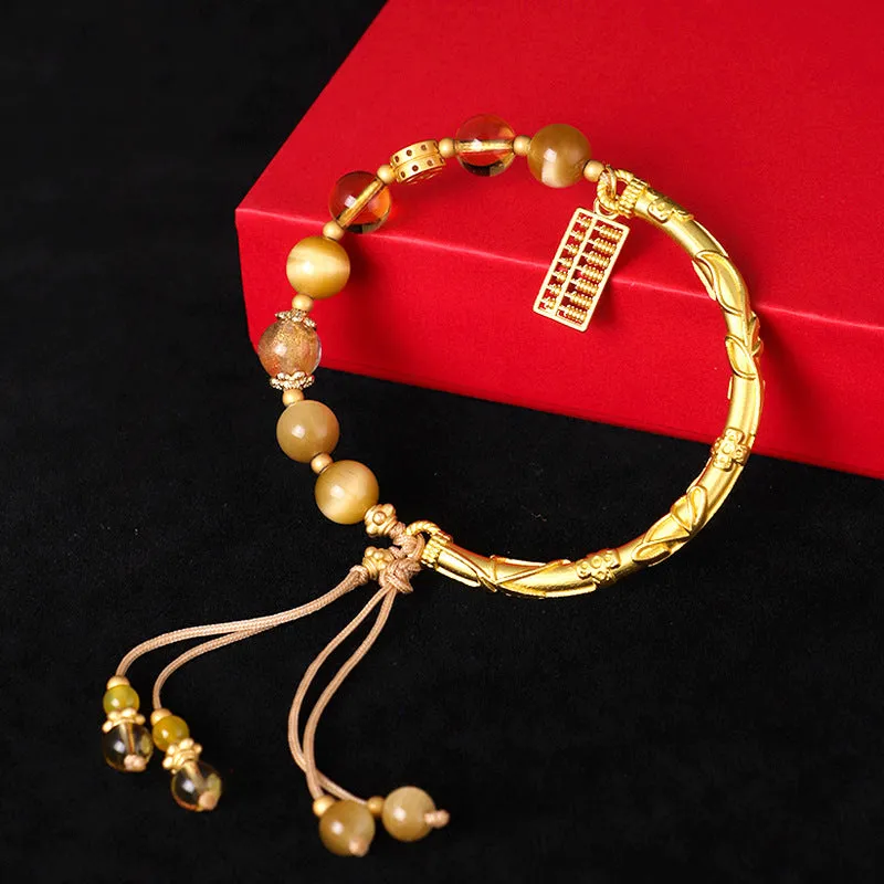 Handmade beaded bracelet with tigereye, citrine stones, and diamond-shaped abacus tag charm