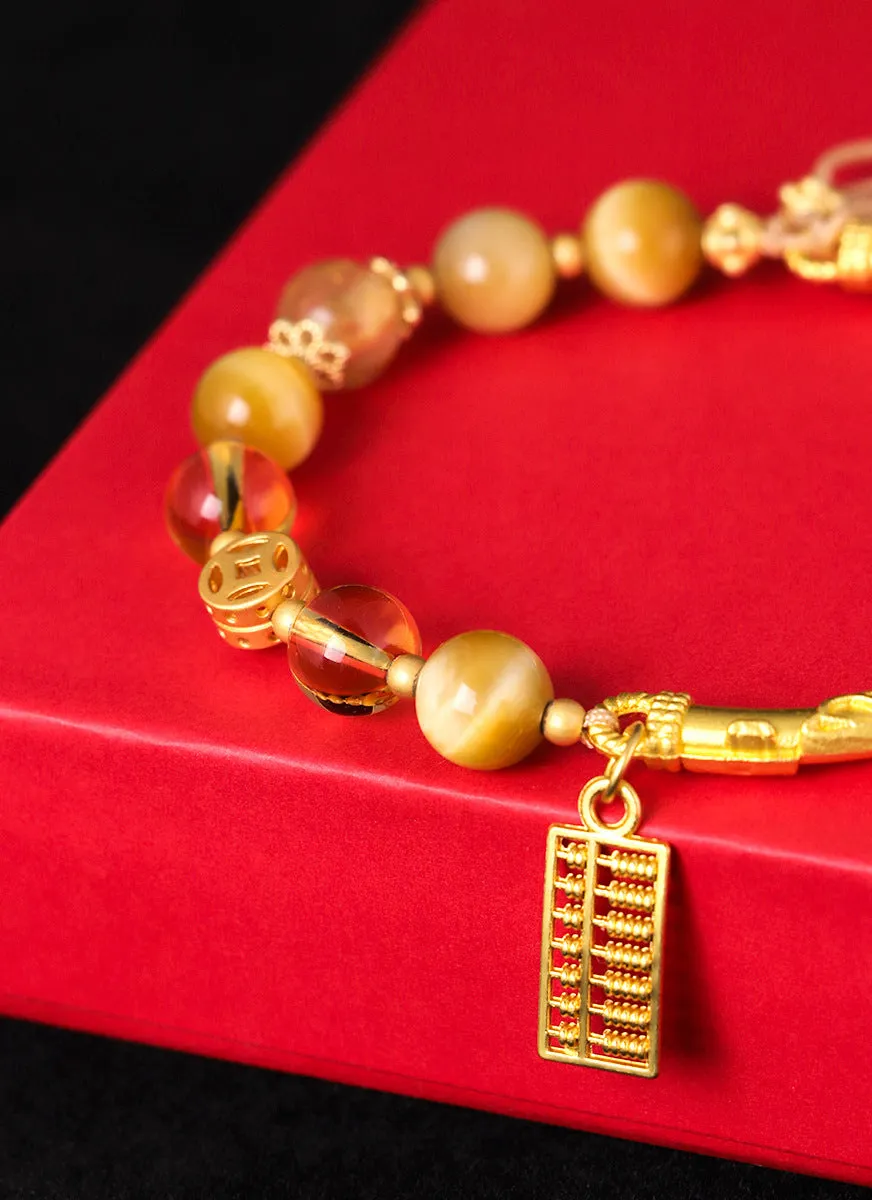 Handmade beaded bracelet with tigereye, citrine stones, and diamond-shaped abacus tag charm