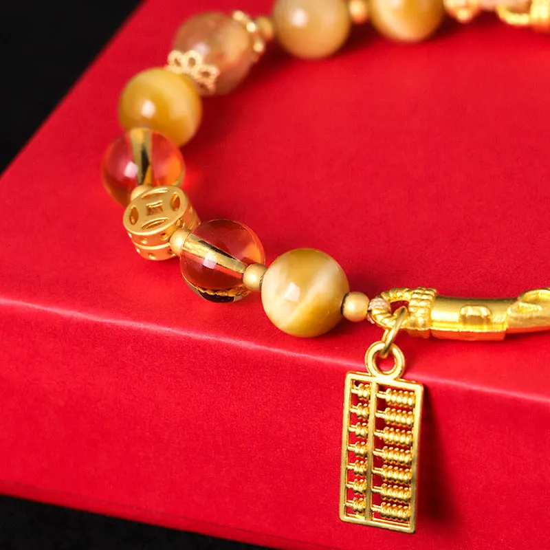 Handmade beaded bracelet with tigereye, citrine stones, and diamond-shaped abacus tag charm