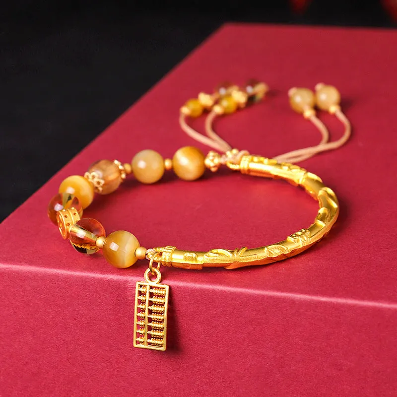 Handmade beaded bracelet with tigereye, citrine stones, and diamond-shaped abacus tag charm