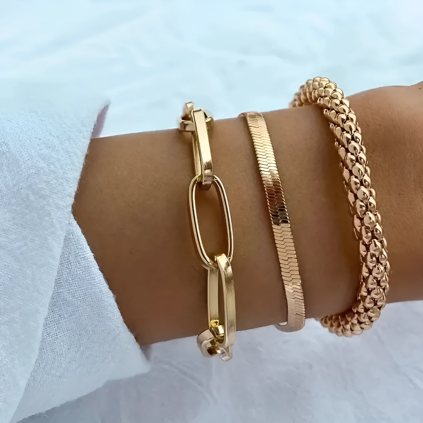 Set of three alloy snake bone chain bracelets in retro geometric design with electroplated gold finish