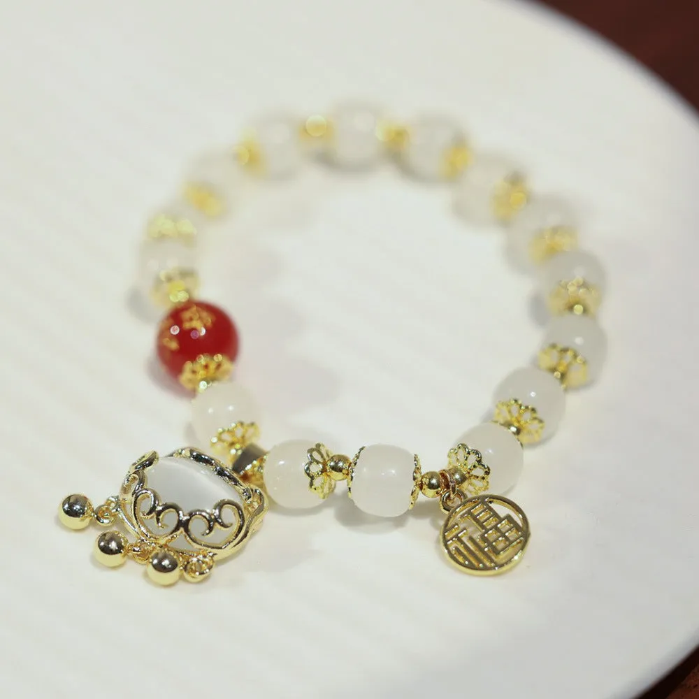 Women's Chinese style glass bracelet with safety lock, fu character, windmill, bamboo, and jade charm elements