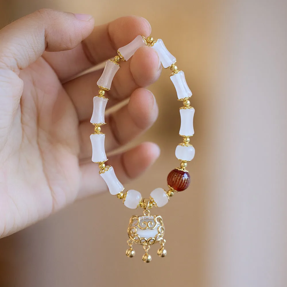 Women's Chinese style glass bracelet with safety lock, fu character, windmill, bamboo, and jade charm elements