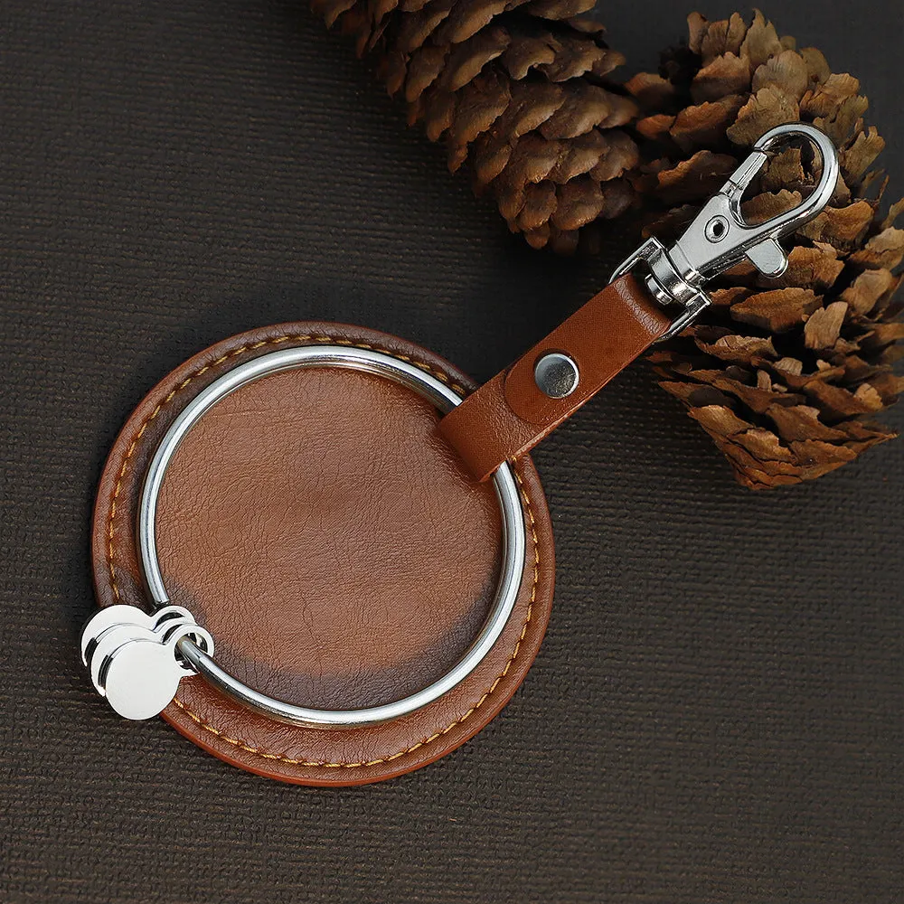 Round genuine leather keychain pendant with steel-coloured stainless steel key ring featuring cross, crown, and Roman numerals pattern