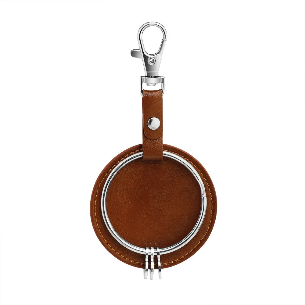 Round genuine leather keychain pendant with steel-coloured stainless steel key ring featuring cross, crown, and Roman numerals pattern