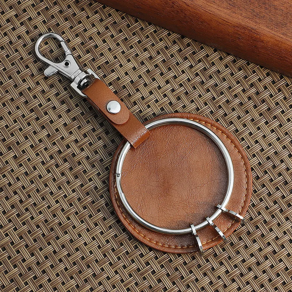 Round genuine leather keychain pendant with steel-coloured stainless steel key ring featuring cross, crown, and Roman numerals pattern
