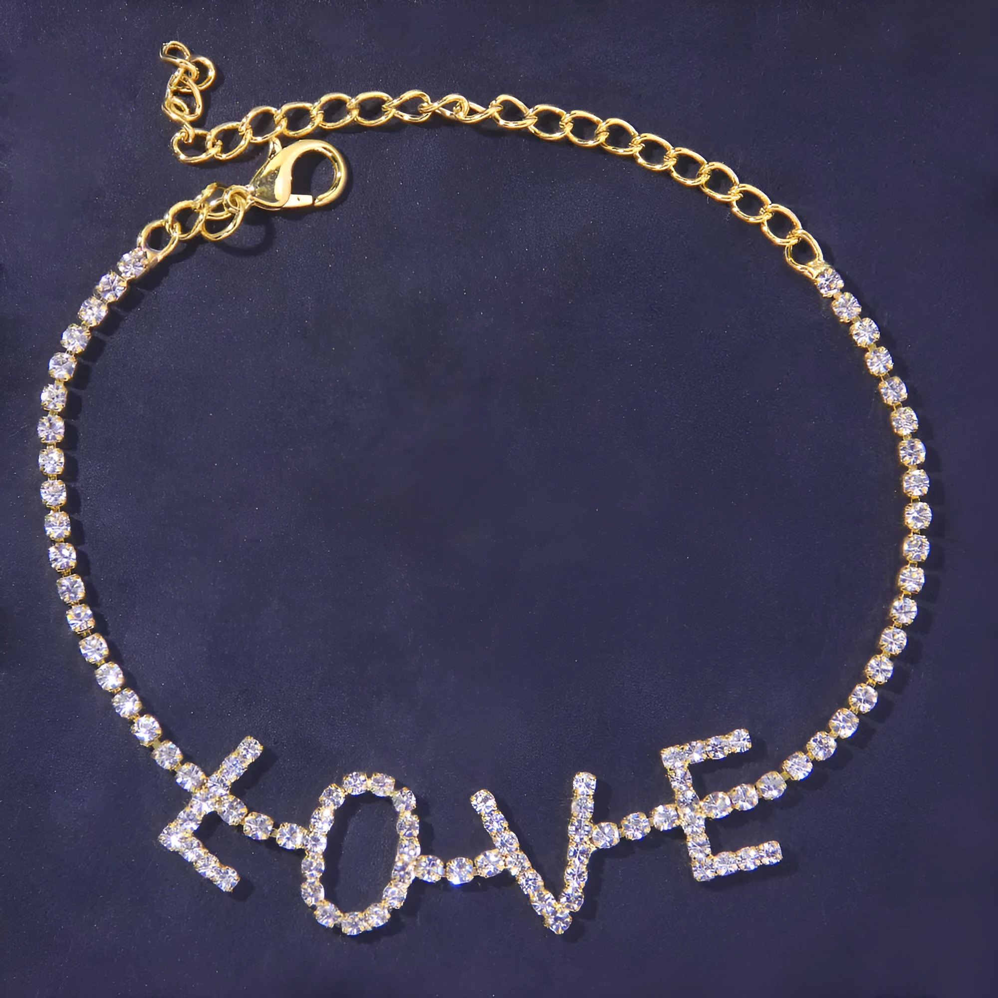 Gold letter anklet spelling LOVE with clear rhinestones on copper chain