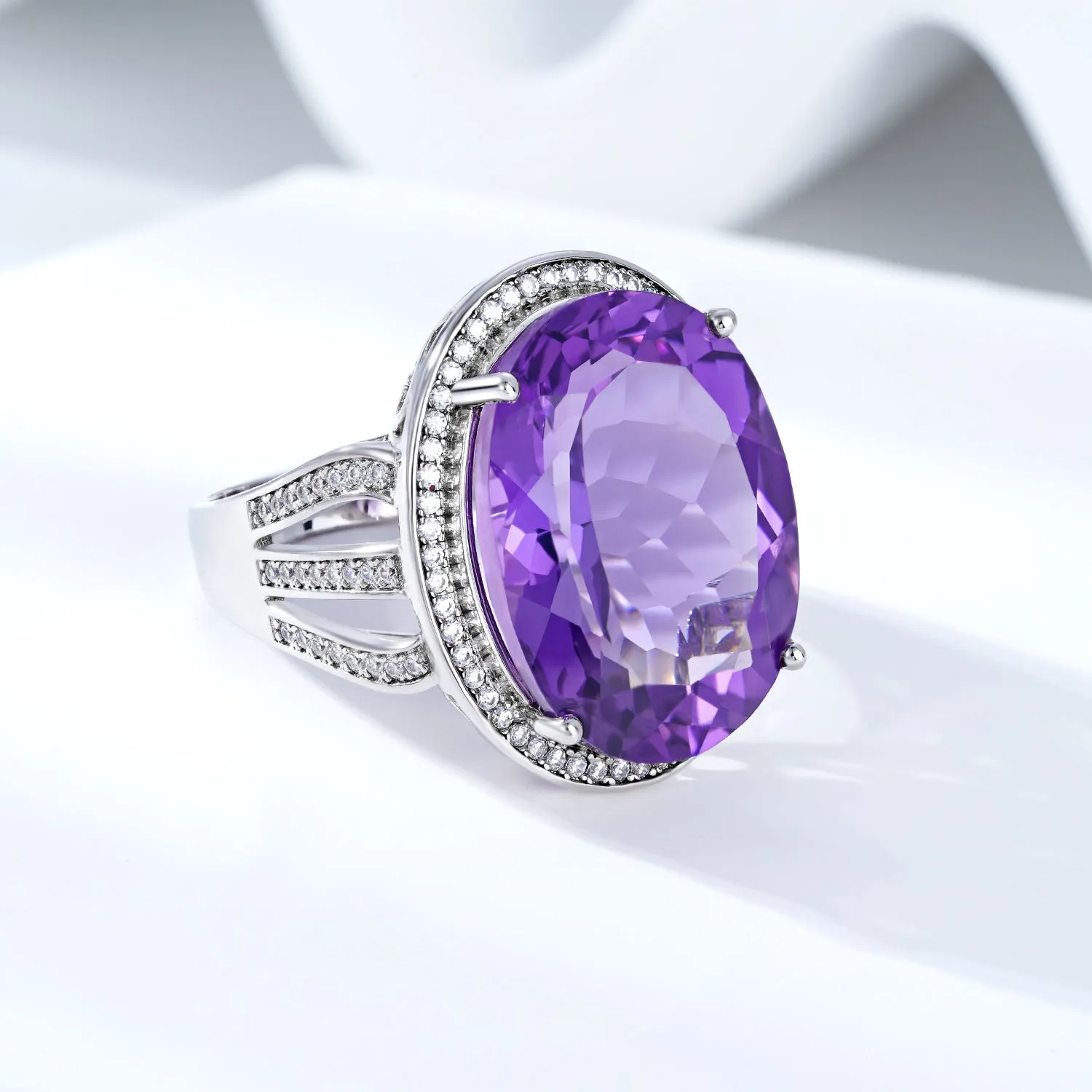 Natural amethyst ring in 925 silver with oval 19-carat stone, white finish, side view on finger