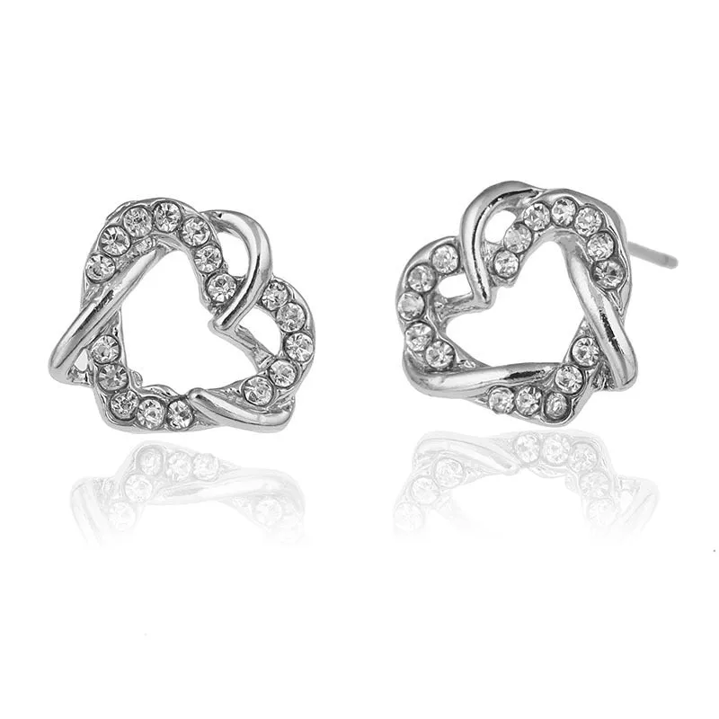 Gold colour alloy heart-shaped stud earrings on white background