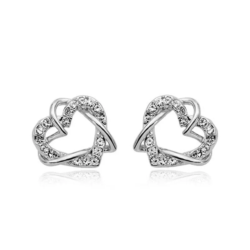 Gold colour alloy heart-shaped stud earrings on white background