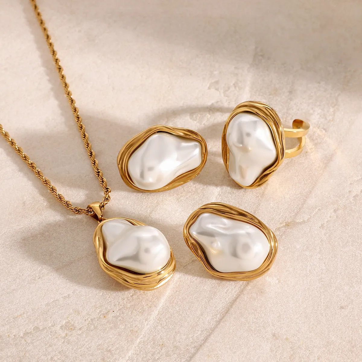 Women's stainless steel necklace with irregular mother pearl shellfish pendant on regular chain, with matching earrings and ring