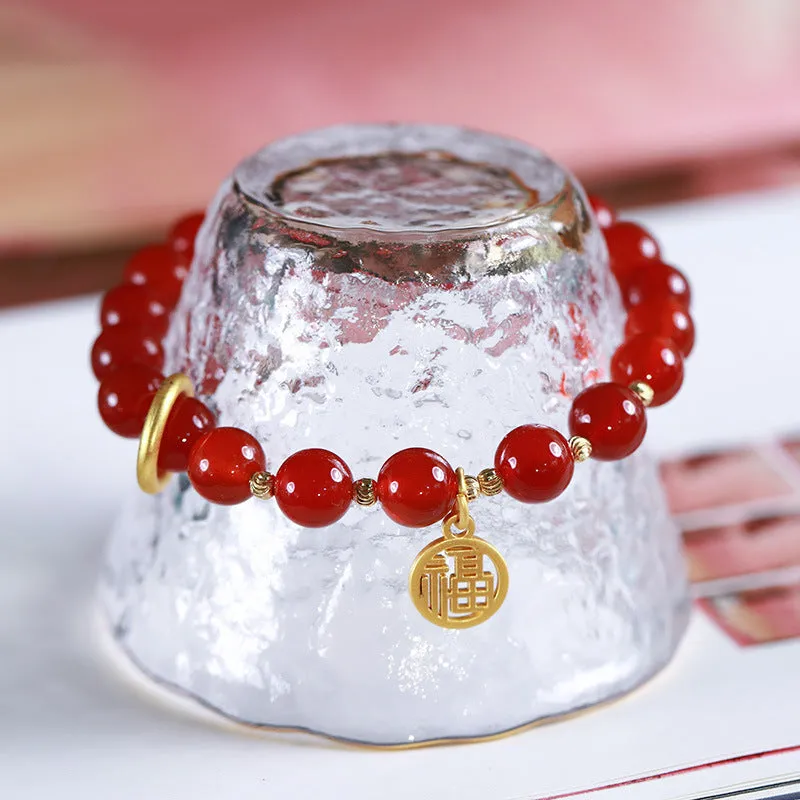 Natural red agate bracelet with woven bead design on a wrist.