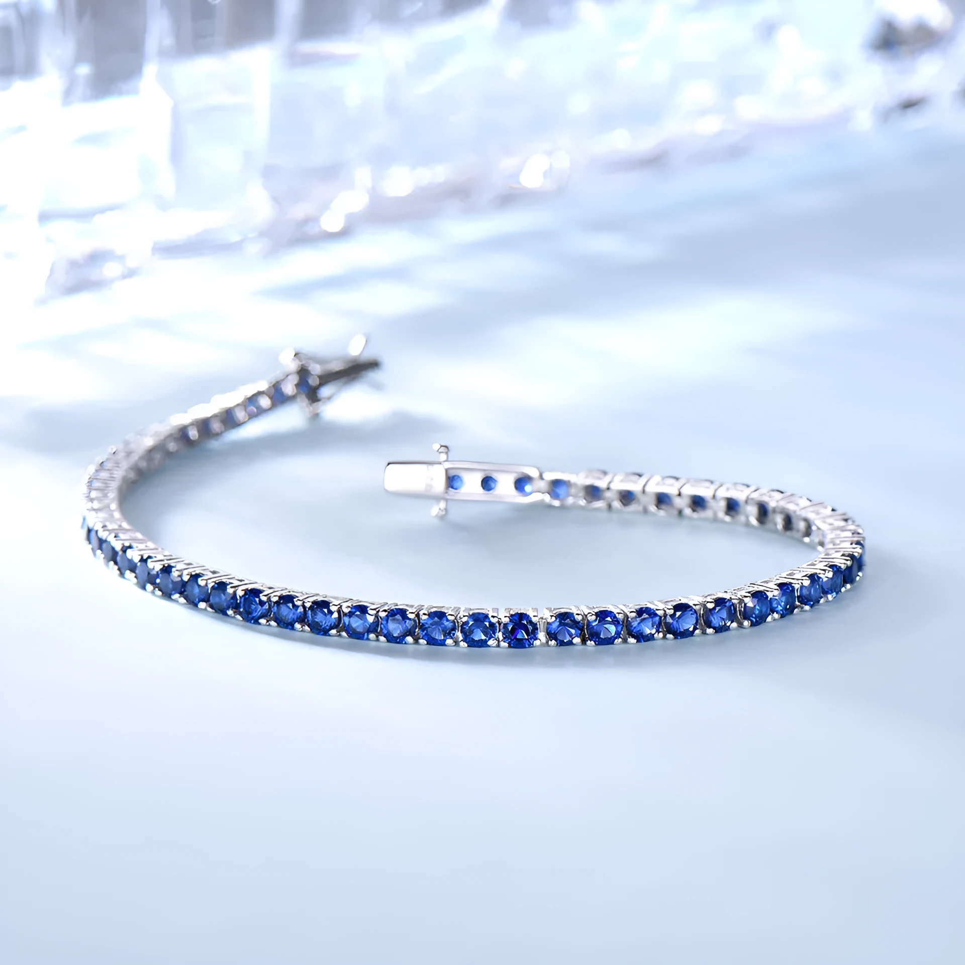 925 sterling silver nano sapphire tennis chain bracelet with drop shape stones on white background
