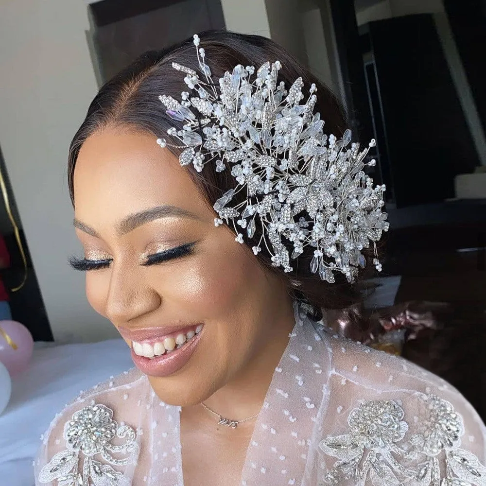 Gold rhinestone wave bridal headpiece and matching earrings set on display