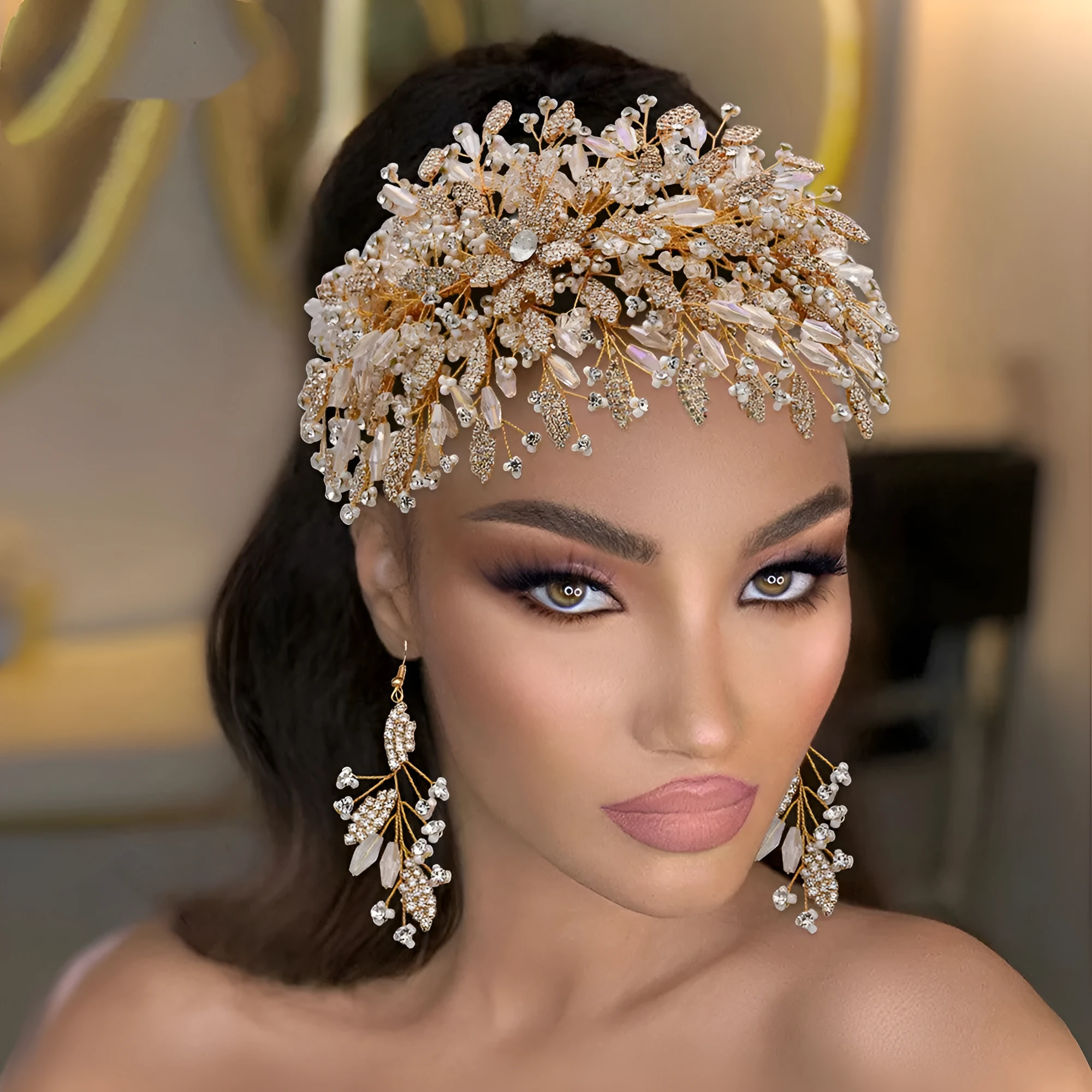 Gold rhinestone wave bridal headpiece and matching earrings set on display